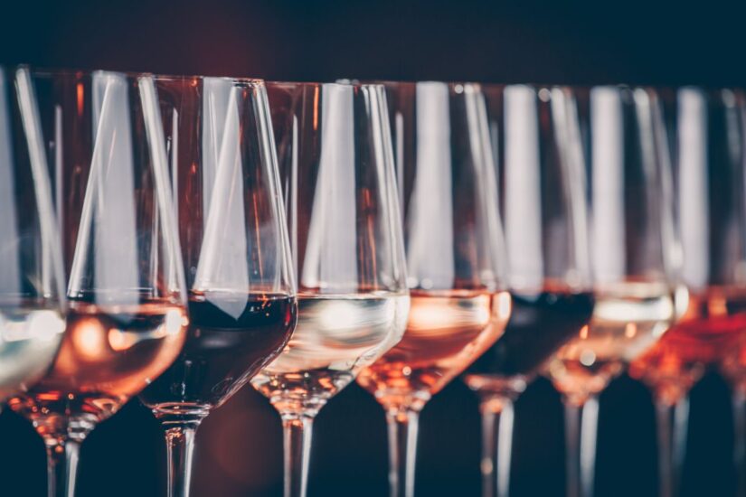 Wine glasses in a row. Buffet table celebration of wine tasting. Nightlife, celebration and entertainment concept Wine glasses in a row. Buffet table celebration of wine tasting. Nightlife, celebration and entertainment concept. Horizontal, cold toned image